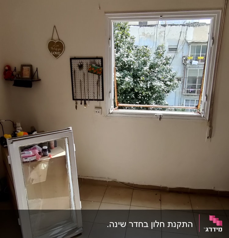חלון אלומיניום פתוח עם מסגרת על הרצפה